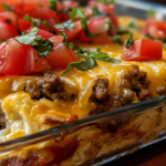 Close-up of a delicious breakfast taco casserole held by hand with a resort island background.