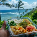 delicious Chicken Salad Wrap held by hand with a tropical resort island background.